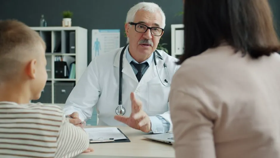 Doctor consulting a family in a clinic office